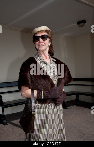 1940`s dressed woman standing in a shelter Stock Photo